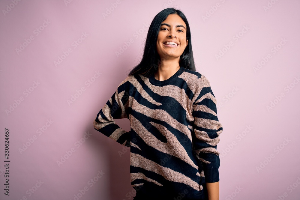 Fototapeta premium Young beautiful woman wearing fashion urban clothes, model wearing casual street style standing over pink background