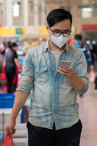 Asian men shopping at the food market photo