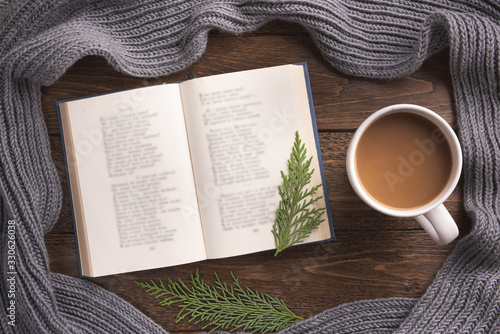 Wallpaper Mural Flatlay composition with white knitted scarf, cup of coffe and open book on wooden desk table. Hygge style, cozy autumn or winter holiday concept. Flat lay, top view, overhead. Torontodigital.ca
