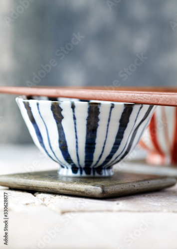 Wooden Chopsticks and ceramic Bowls on bright background.
