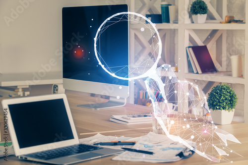 Desktop computer background in office and start up theme hologram drawing. Double exposure. Startup concept.