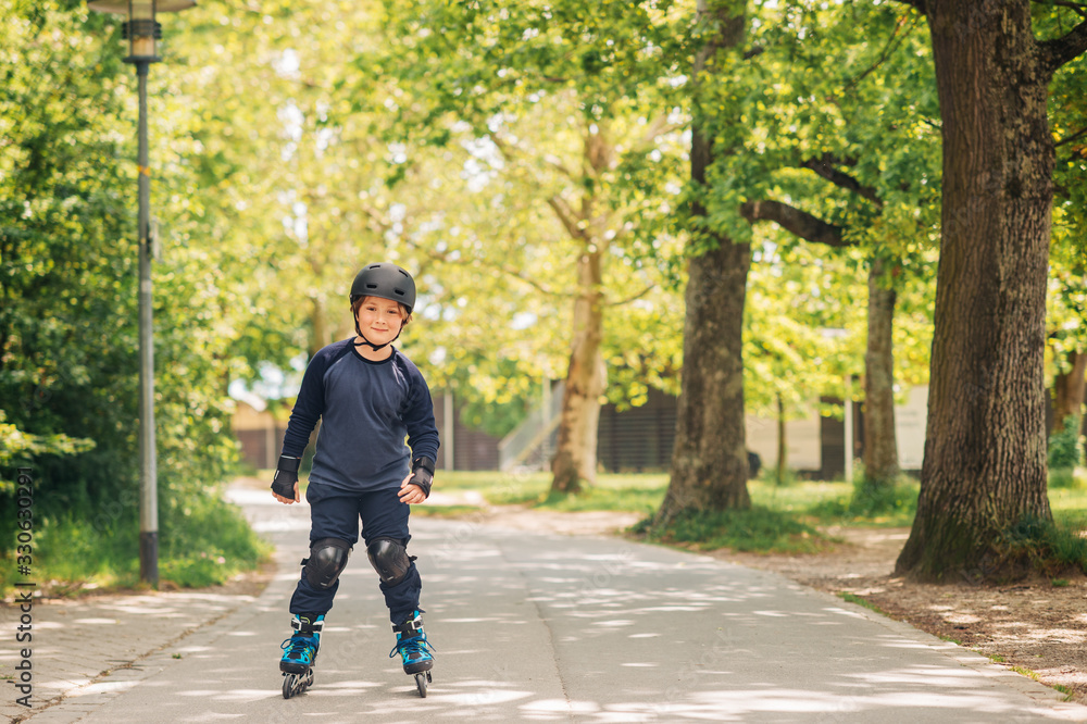 Active little boy skating in summer park, healthy lifestyle for children Active little boy skating in summer park, healthy lifestyle for children