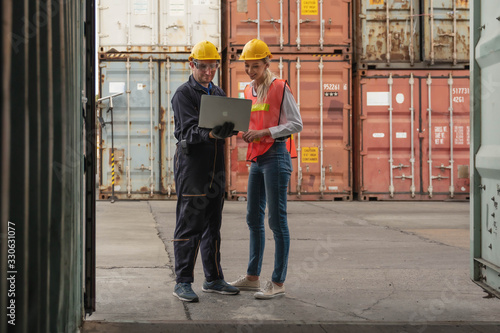 industrial background of containers cargo inspector working with shipping agent to inspect goods in container at containers yard and cargo