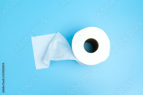 One toilet paper roll isolated on blue background photo