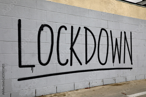 Coronavirus lockdown graffiti spray painted on brick wall photo