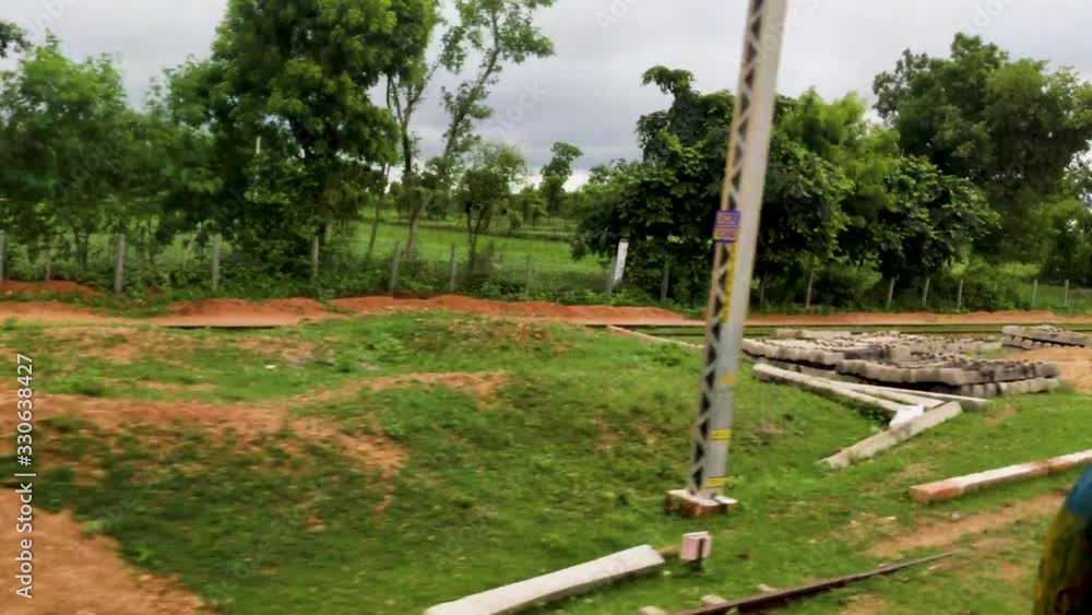 A countryside view from train door running fast on the track. A countryside view from train door running fast on the track.
