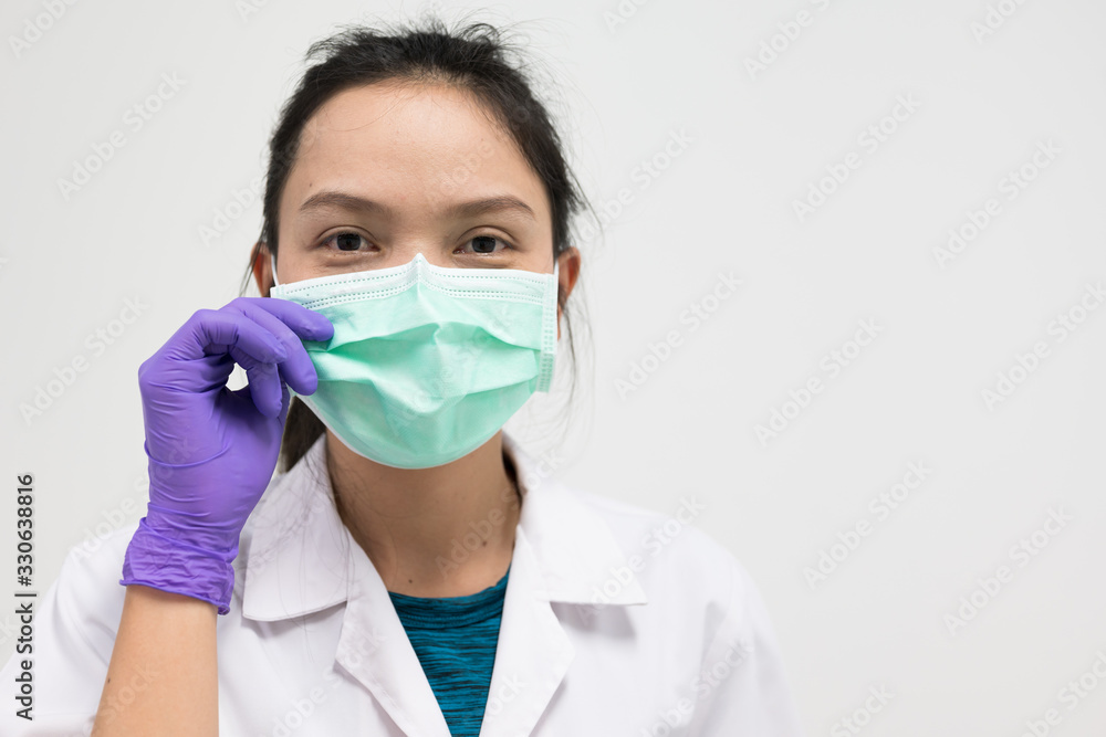 Portrait Asian woman wearing medical mask .Young girl wearing mouth mask against air smog pollution. Concept of corona virus quarantine or covid-19.Protection against virus and infection control. Portrait Asian woman wearing medical mask .Young girl wearing mouth mask against air smog pollution. Concept of corona virus quarantine or covid-19.Protection against virus and infection control.