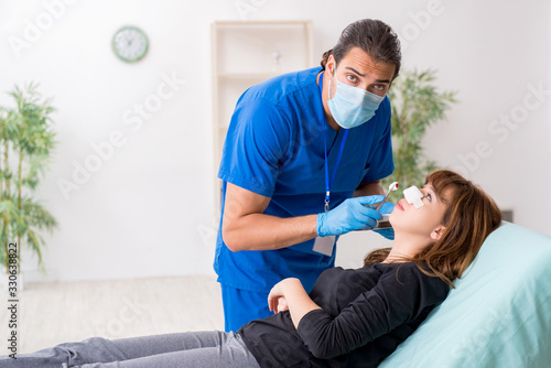 Young beautiful woman visiting doctor in plastic surgery concept