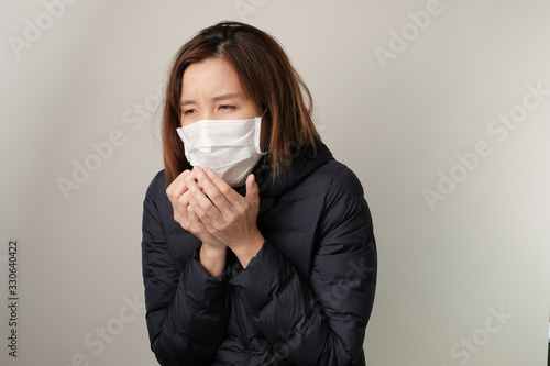 asian woman sneezing and wear the medical mask to protect and fight infection from germ, bacteria, covid19, corona , sars , influenza virus on white background. Sick and illness concept photo