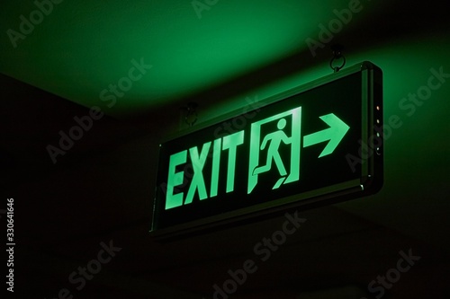 Emergency exit sign glowing in the dark