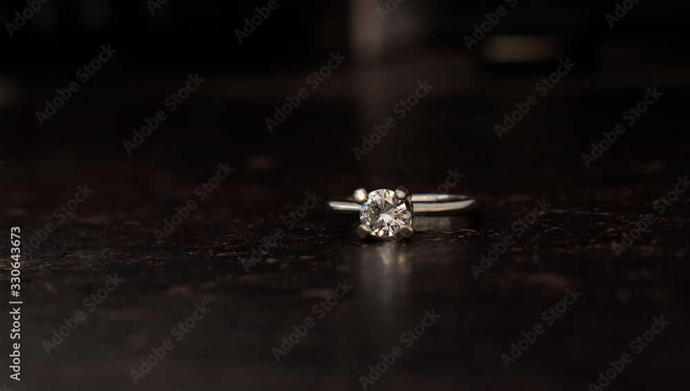 Wedding ring Is a diamond ring on the wooden floor Wedding ring Is a diamond ring on the wooden floor