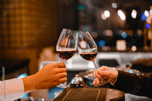 Two bartender enjoying of Cheers glass of wine for wine tasting event in a restaurant  at sunset. bartender, tasting, Dinner, Wine, beverage, dinner concept.