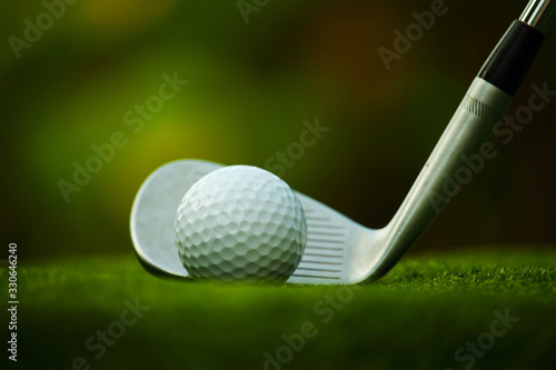 golf club and golf ball close up in grass field with sunset. Golf ball close up in golf coures