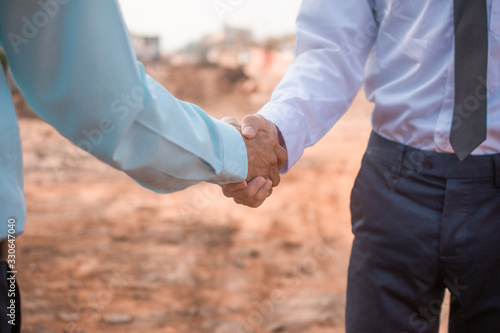 Contractor partnership shake hands at construction site © Suriyo