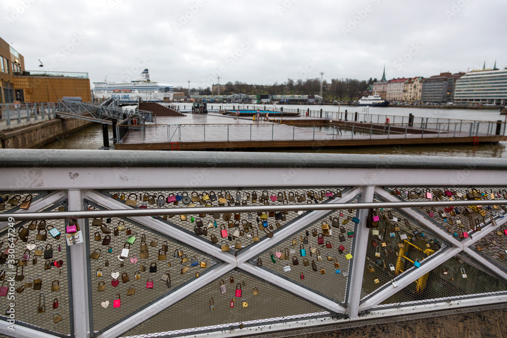 Love padlocks on the fence of the bridge in Helsiki
