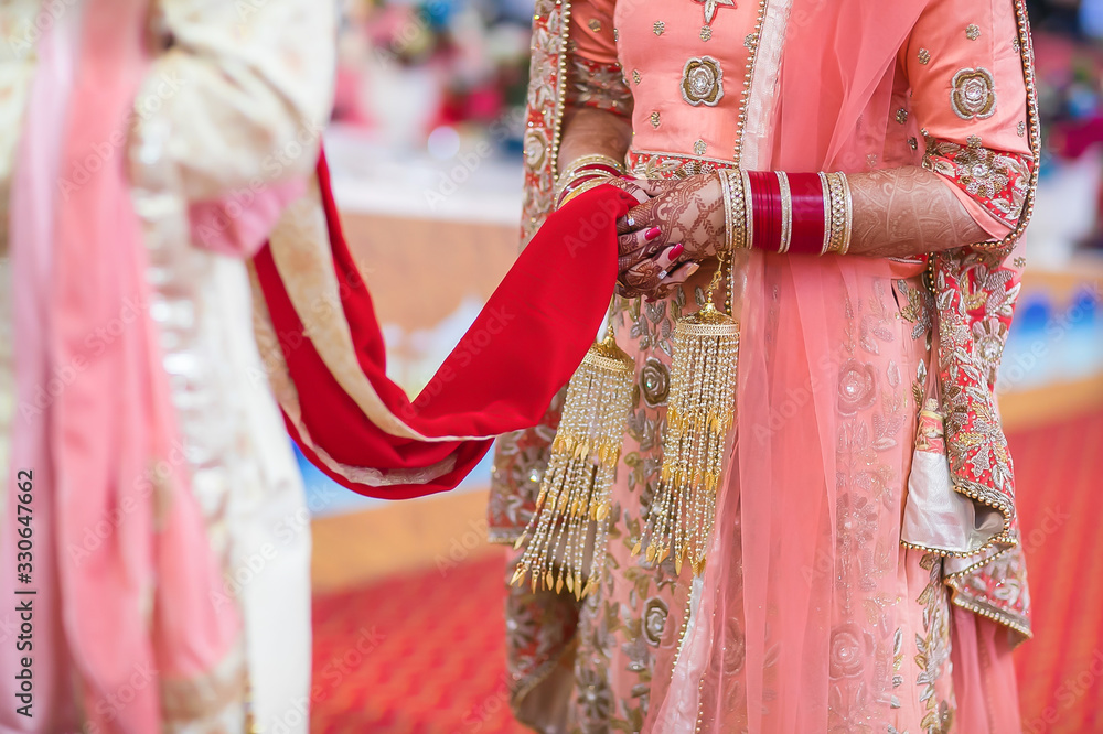 Indian Punjabi Sikh Wedding ritual items and hands close ups