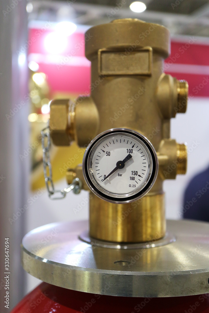 An image of a working pressure gauge with an emergency pressure relief valve of a gas cylinder. An image of a working pressure gauge with an emergency pressure relief valve of a gas cylinder.