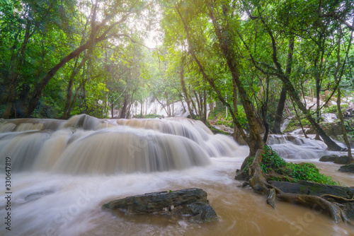 Waterfall scene at Pha Tad Waterfalls in rainforest at the Khuean Srinagarindra National Park Kanchanaburi.
