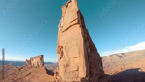 Cliff diving with a cinewhoop FPV drone on a stone column near Moab National Park Utah, exhilarating stunts, flips photo