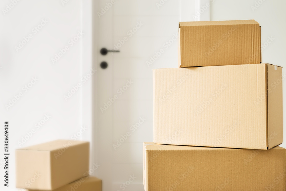 Moving home concept. Packed boxes with stuff in living room. Space for text Moving home concept. Packed boxes with stuff in living room. Space for text