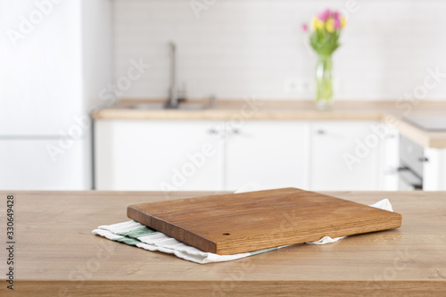 kitchen cutting board on the kitchen table top on blur kitchen background with place for montage product display