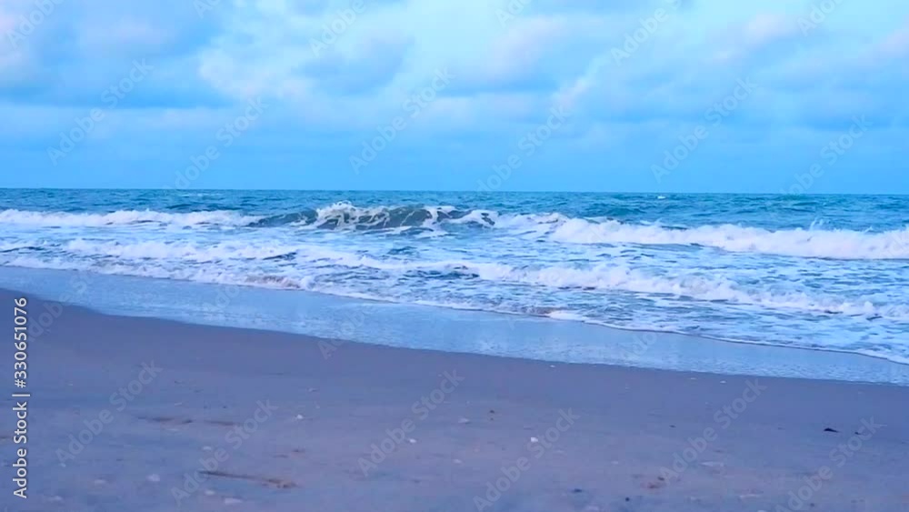 The beach with white waves during sunset at Maharat beach, Songkhla, Thailand The beach with white waves during sunset at Maharat beach, Songkhla, Thailand