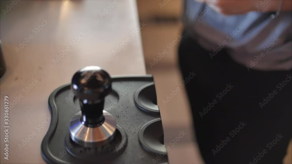 Making Ground Coffee with Tamping fresh coffee. Close-Up. Making coffee from start to finish.Tamping Fresh Ground Coffee. Professional barista. Making Ground Coffee with Tamping fresh coffee. Close-Up. Making coffee from start to finish.Tamping Fresh Ground Coffee. Professional barista.