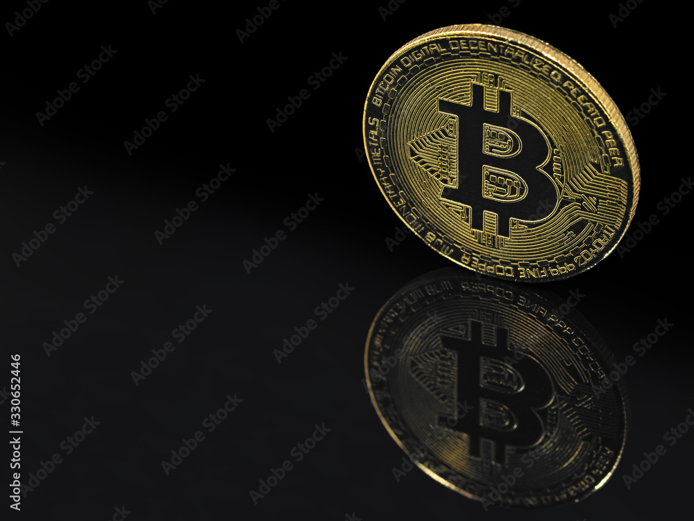 golden bitcoin on black background with reflection and copy space golden bitcoin on black background with reflection and copy space