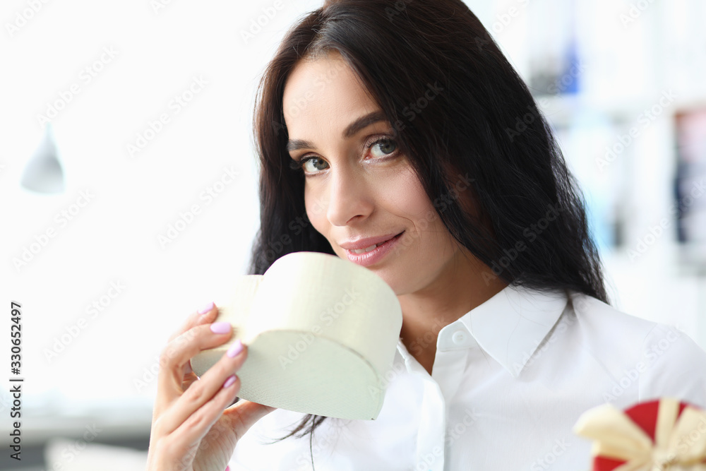 Girl inhales fragrance from gift in form heart. Personal shopping assistant. Stylist will initially choose only right ones. Relax on shopping and exhale with relief when you see result Girl inhales fragrance from gift in form heart. Personal shopping assistant. Stylist will initially choose only right ones. Relax on shopping and exhale with relief when you see result