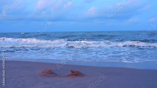 The beach with white waves during sunset at Maharat beach, Songkhla, Thailand photo