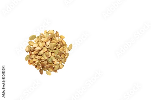 Peeled pumpkin seeds isolated on white background. Copy space.