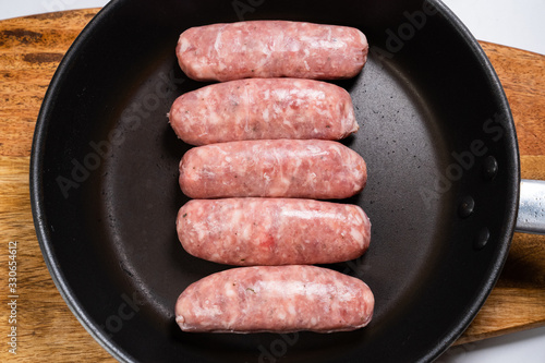 raw sausages fried in pan semi-finished view top