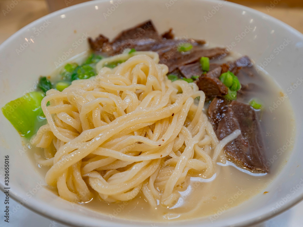 Close up shot of a bowl of delicious beef hand pulled noodle Close up shot of a bowl of delicious beef hand pulled noodle