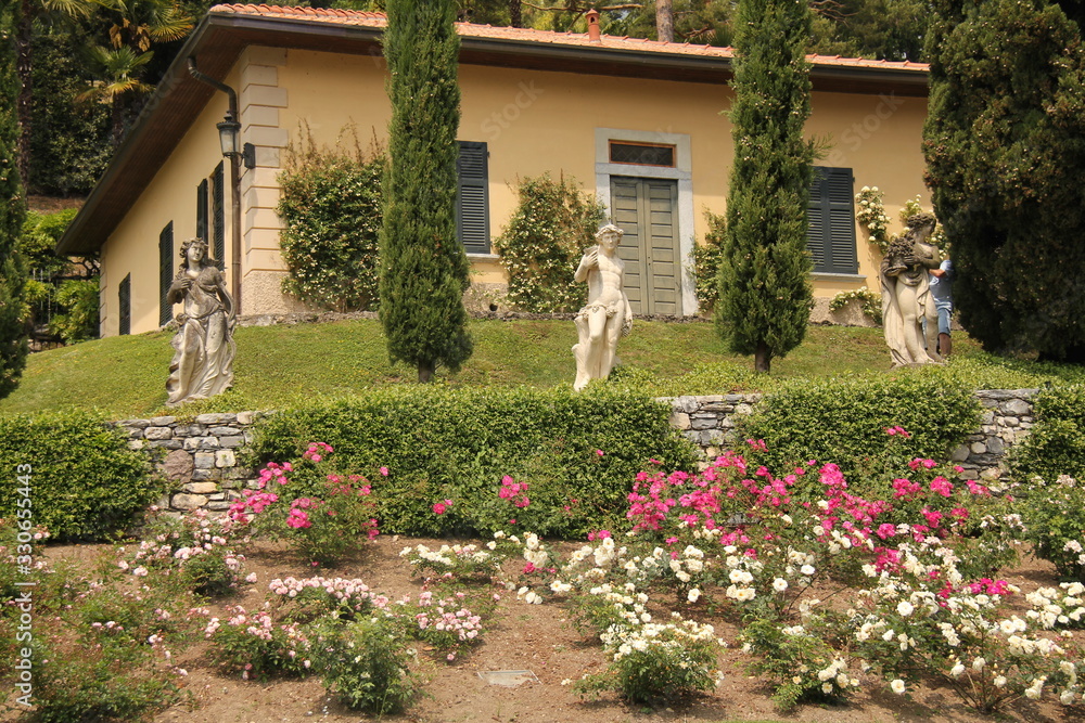 Three Statues with Colorful Flowers