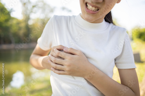 Asian child girl touching her breasts sore with severe pain in her chest,teenage girl feel menstrual breast pain,hormonal or growth in to adolescents cause irritation,painful engorgement to the breast