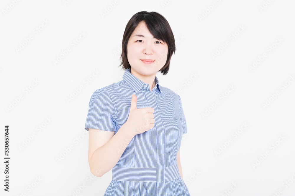 グッドのポーズをするワンピースを着た女性 グッドのポーズをするワンピースを着た女性