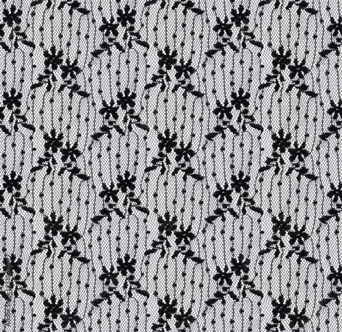 Seamless pattern in the form of an elegant translucent black lace on a white background. Lace with floral motifs.