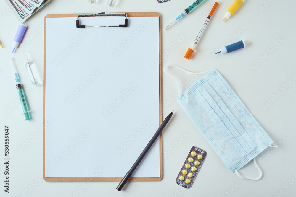 Top view of medical items and empty paper blank sheet on the white background. Healthcare and medicine concept Top view of medical items and empty paper blank sheet on the white background. Healthcare and medicine concept
