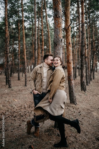 Love story of Oleg and Anastasia. Stylish photo shoot in the forest in cloudy weather.