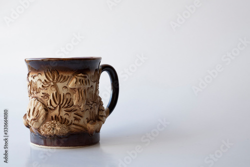 beautiful clay cup on a white background