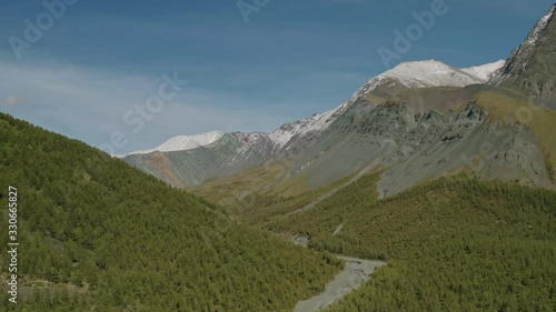 Wallpaper Mural Hillsides panorama, sunny slopes with dense conifer forest, snowy scree rocks Torontodigital.ca
