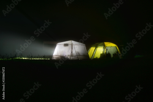 Campground at night. Bright light in the tent city