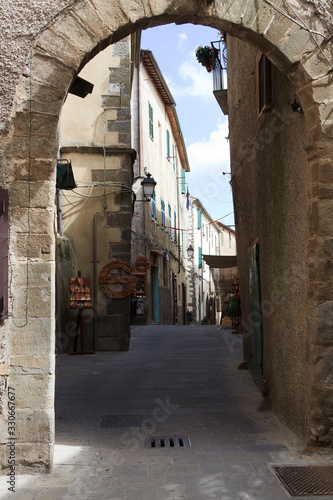 Scansano (GR), Italy - June 10, 2017: A central road and typical houses in Scansano, Grosseto, Tuscany, Italy
