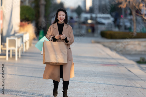 A young Asian woman is shopping at a shopping mall