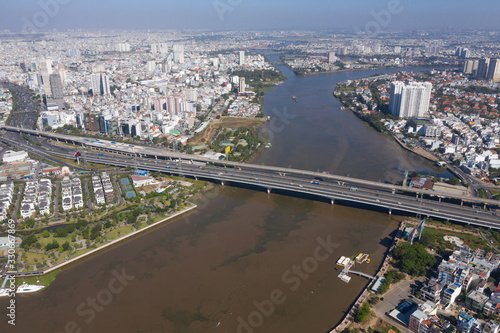 Top view aerial photo from flying drone of a Ho Chi Minh City with development buildings, transportation, energy power infrastructure