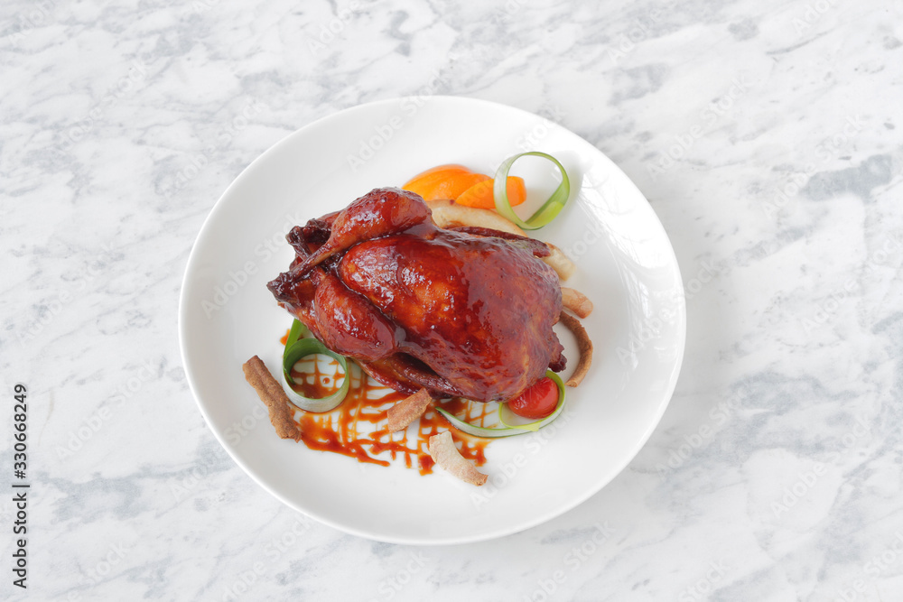 Baked, tasty juicy, quail with spices herbs and soy sauce, beautifully served on a marble table Baked, tasty juicy, quail with spices herbs and soy sauce, beautifully served on a marble table