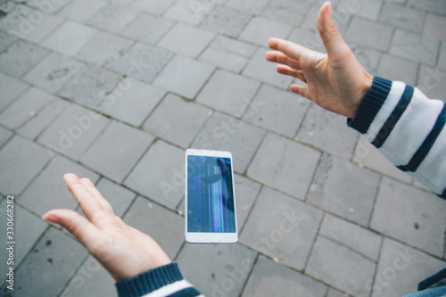 Obraz na plátně hands holding phone with broken cracked screen