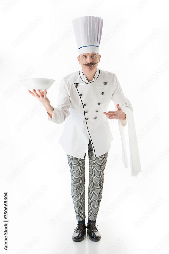 Elegant chef cook posing with a plate on a white background Elegant chef cook posing with a plate on a white background