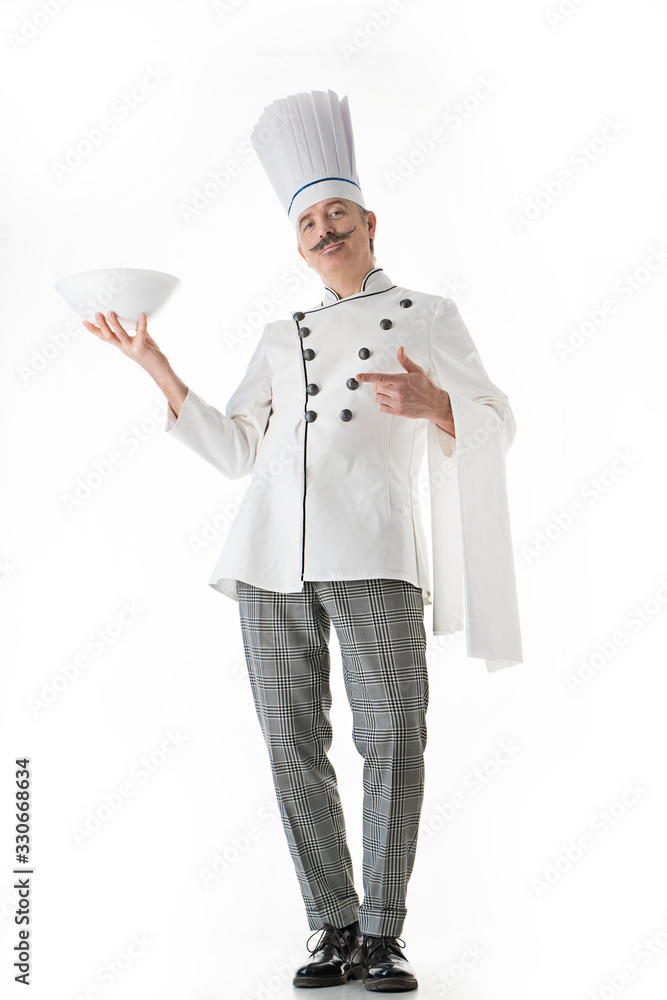 Elegant chef cook posing with a plate on a white background Elegant chef cook posing with a plate on a white background