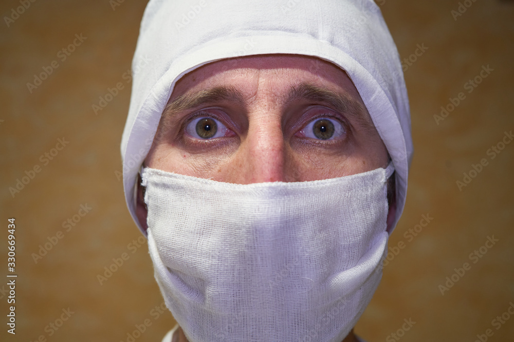 mask on the face of a doctor,medical worker in face mask with frightened face, protection against coronavirus mask on the face of a doctor,medical worker in face mask with frightened face, protection against coronavirus